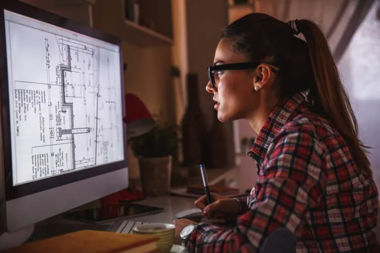 Woman looking at blueprints on screen