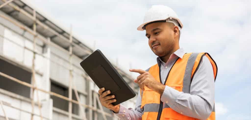 A construction man works on his tablet to ensure data security.