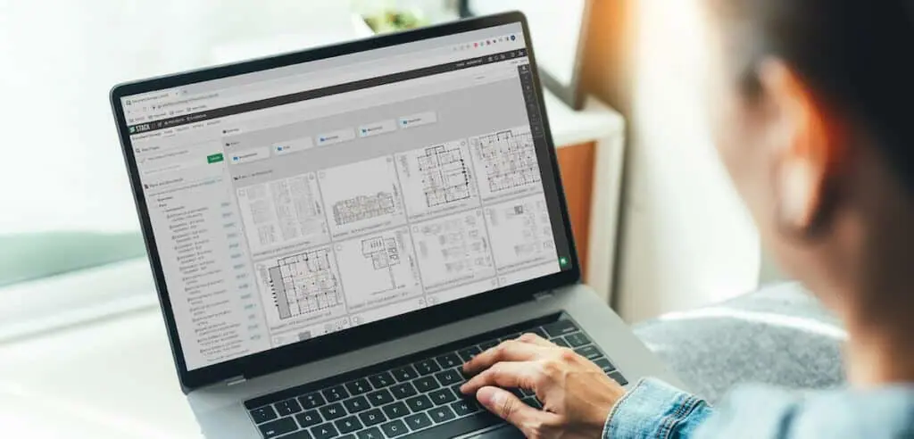 A man looks at his computer screen, which shows STACK's folder structure to aid in document management.