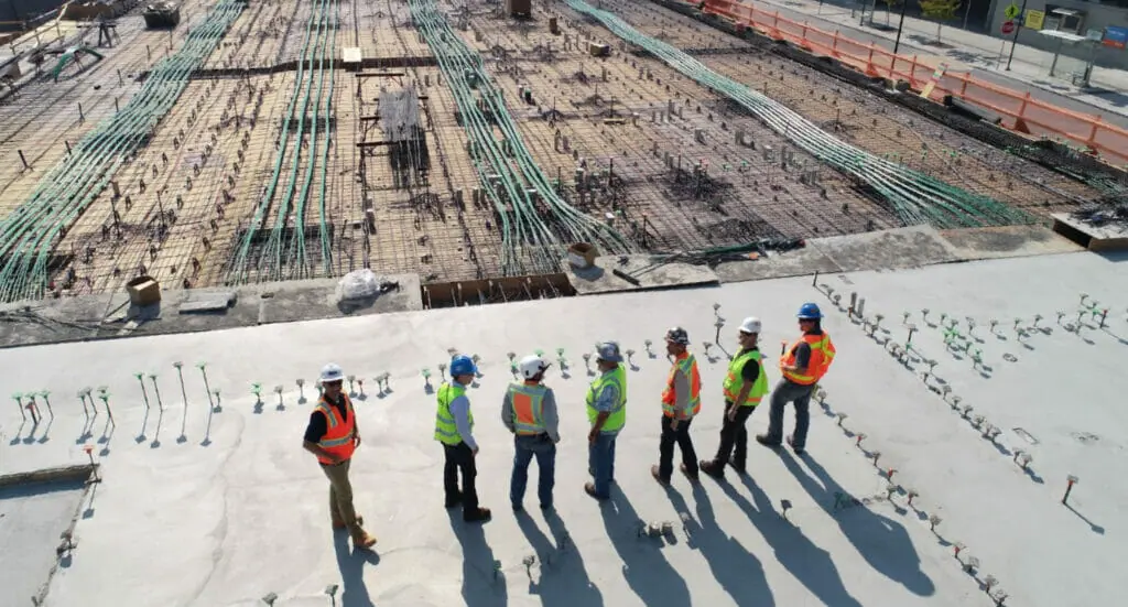 Construction workers look out at their construction site.