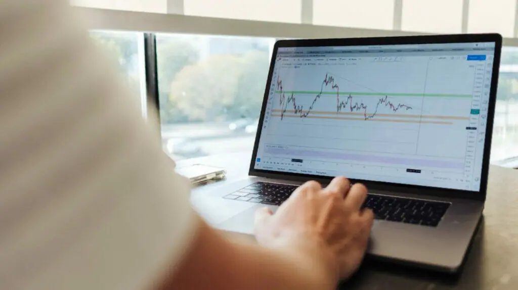 Man looks at accounting numbers on his Macbook.