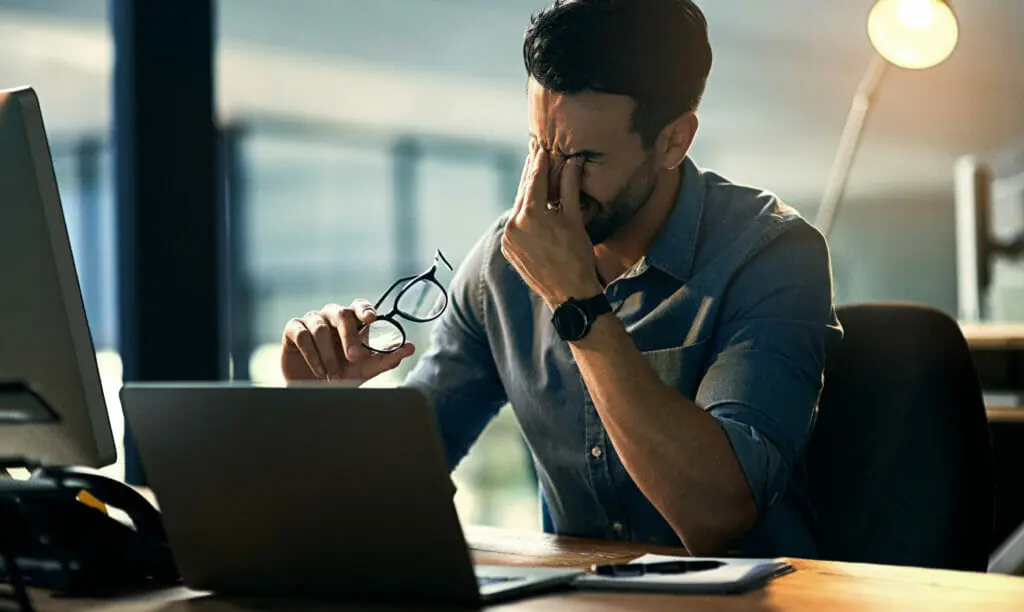 Man is frustrated with his on-premises computer set-up.