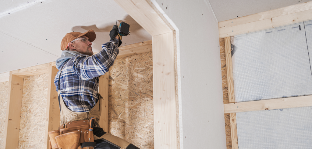 Man installing drywall.