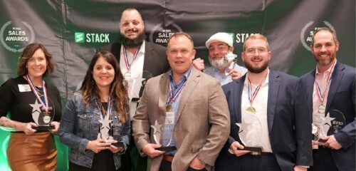 STACK Sales staff pose for a photo with their awards from the 2022 Sales Awards.