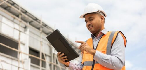 A construction man works on his tablet to ensure data security.