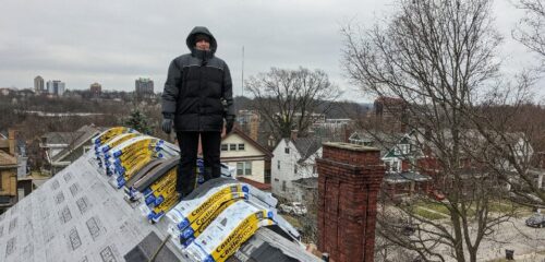 Allison Hunter, Senior Project Manager, stands on the roof of a construction project.