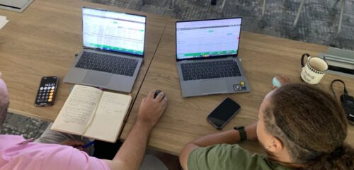 STACK Staff work on laptops to participate in the estimating workshop.